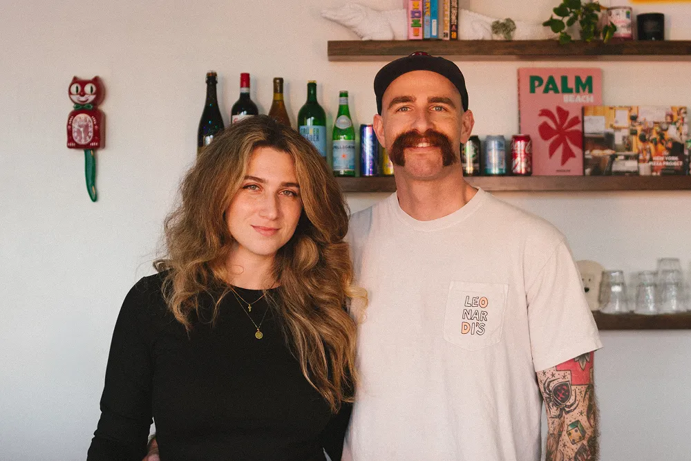 Man and woman standing in cozy kitchen.